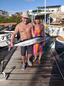 Real fisherman and woman on a real fishe