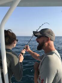 Aaron and his daughter fighting a monster fish!