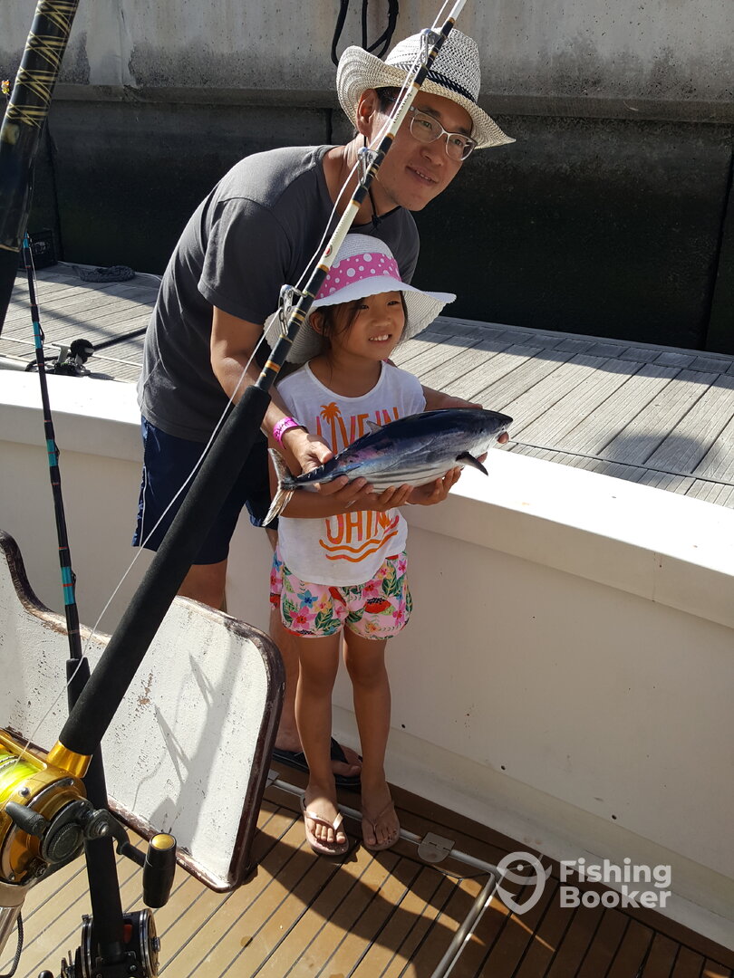 Happily showing off one of the fish caught by Dad!