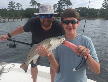 The boys showed dad how to catch redfish