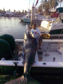 Captain Scubie with big Marlin fishing aboard the Super panga 