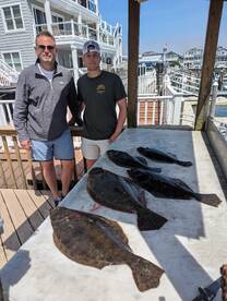 Father and son with nice flounder catch