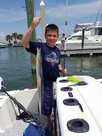 Logan holding his weird fish of the day.