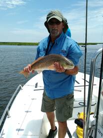 Capt. Joe with a Redfish he pulled up.