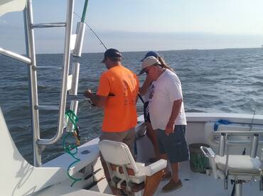 Father and daughter battling it out on the starboard side with the captain putting in his two cents