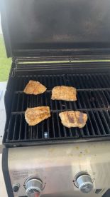 Grilled fish fillets on a barbecue grill, showcasing a delicious meal preparation.