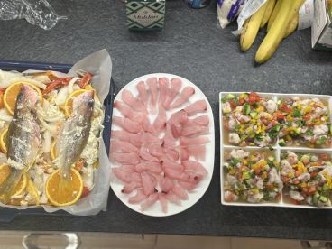 Freshly prepared fish dishes featuring fillets and ceviche, showcasing a variety of seafood ready for a delicious meal.