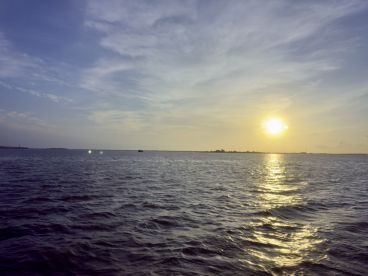 A serene view of the water at sunset, capturing the tranquil fishing environment.