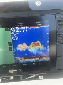 Sonar display showing fish activity at a depth of 92.7 feet, indicating a productive fishing area.