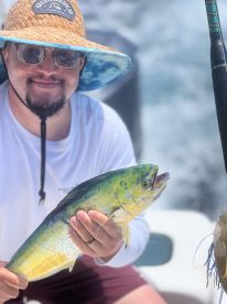 An angler proudly displaying a vibrant Mahi Mahi while fishing on a boat, showcasing the excitement of a successful catch.