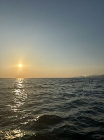 A serene sunset over the ocean, capturing the tranquil beauty of a fishing environment.