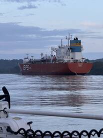 A large gas tanker named 'Winnipeg' navigating through calm waters, showcasing its impressive size against a scenic backdrop.