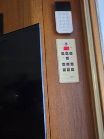 Interior view of a boat showcasing electronic controls and a display screen, highlighting the modern amenities available for a comfortable fishing experience.