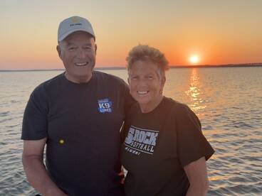 A couple enjoying a sunset on the water, capturing a serene moment during their fishing trip.