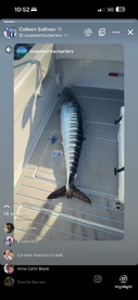 A large Wahoo is stored in the cooler of a fishing boat, showcasing a successful offshore fishing trip.