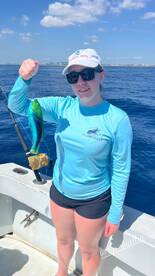 Young angler proudly displaying a vibrant Mahi Mahi while fishing in the Florida Keys.