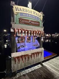A display of freshly caught Red Snapper hanging on a board at HarborWalk Marina, showcasing a successful fishing trip at night.