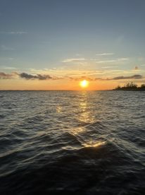 A serene sunset over the water, capturing the tranquil beauty of the fishing environment.